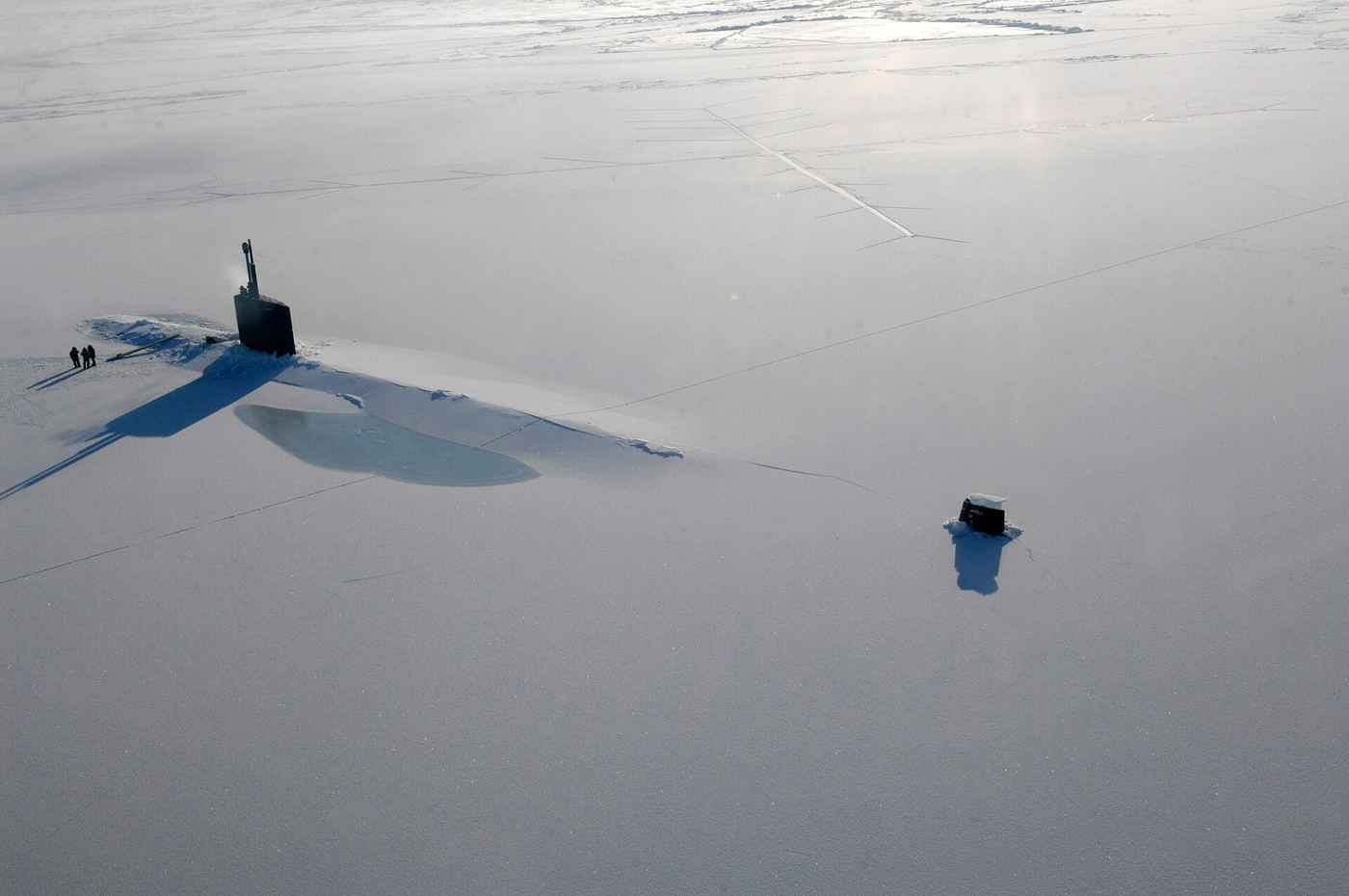broken arctic sea ice floating on dark ocean water